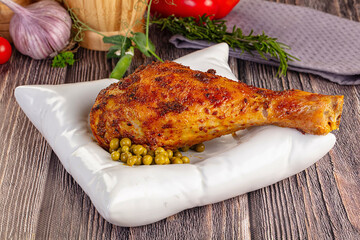 Baked turkey drumstick served green peas