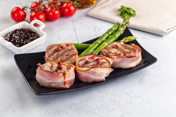 Tasty grilled pork medallion with bacon