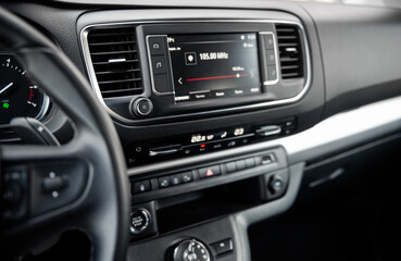 Fototapeta premium Close up shot of infotainment system in the car. Listening to radio in a spacious vehicle interior. 