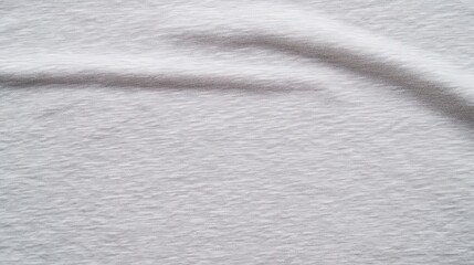 Naklejka premium A smooth, textured fabric in soft white tones, exhibiting subtle shadows and gentle folds.