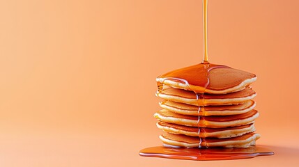Golden Pancakes with Syrup Drizzle on Orange Background