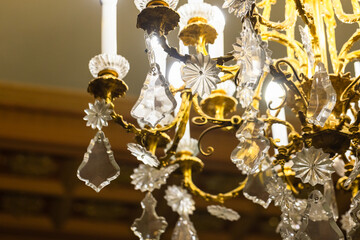 A beautifully ornate chandelier featuring golden metalwork