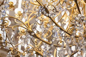 Golden crystal chandelier sparkling under bright lights