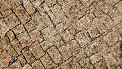 Stone floor, with its aged texture and old pavement, provides a rustic background that highlights the character of the sidewalk and its weathered charm.