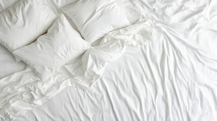 Obraz premium Comfortable Bedding Arrangement with White Sheets and Pillows in Disarray for Relaxation and Sleep