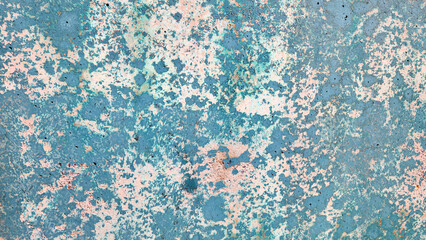 Old plywood, with its cracked and peeling blue paint, creates a vintage background that showcases its weathered charm in an outdoor setting.