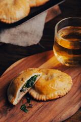 Freshly Baked Hand Pies Filled with Blue Chives and Mushrooms and Sliced One Pie
