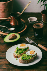 Two avocado toasts with boiled egg