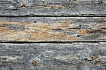 Obraz premium Weathered gray and brown wooden planks showing age and texture.
