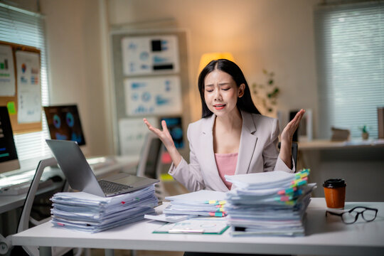Young professional feeling overwhelmed by workload, struggling with paperwork and administrative tasks