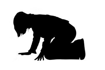 silhouette of a woman who is on her knees on the floor looking for something