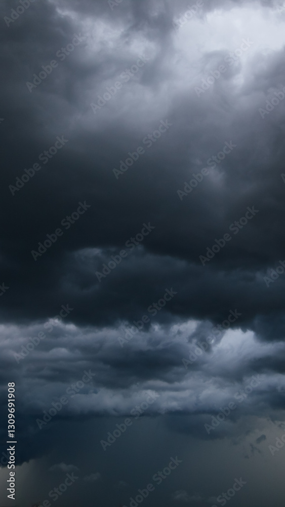 Poster A menacing dark sky filled with thick clouds signals bad weather approaching, highlighting the intensity and unpredictability of stormy atmospheric conditions.
