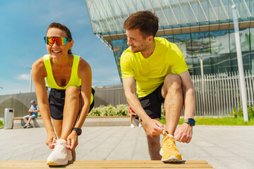 Exercise enthusiasts prepare for a morning run at a modern outdoor park on a sunny day