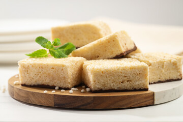 Delicious puffed rice bars and mint on white table, closeup