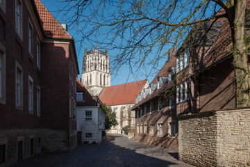 Outdoor exterior sunny view of Spiegelturm Brücke to Überwasserkirche Gothic church in Münster, Germany. 