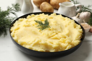 Delicious mashed potato with dill served on white table, closeup