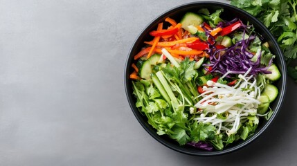 Vibrant vegetable salad in a black bowl, featuring carrots, cucumbers, bell peppers, red cabbage, cilantro, and bean sprouts.  A healthy and colorful meal.