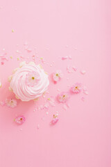 pink  cupcake with spring flowers  on pink  background