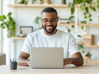 Young Man Smiling While Working on Laptop Interior