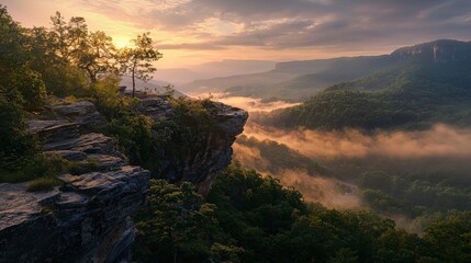 Sunset over cliff with rolling hills and misty valley