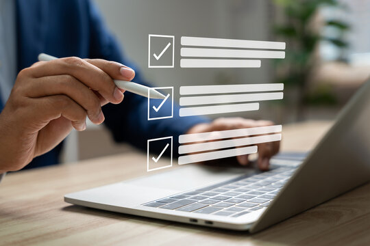 Business performance monitoring and evaluation concept, Take an assessment, Business man using laptop and tablet online checklist survey, Filling out digital checklist, Questionnaire with checkboxes.