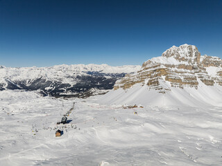 Aerial drone view of sunny winter in dolomites, alps. Italy, Madonna di Campiglio village and a ski...