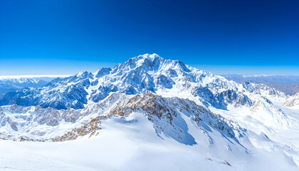 Fototapeta premium Majestic snow-capped mountain peak under a vibrant blue sky.