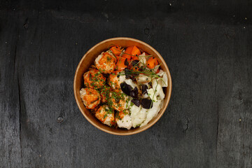 A wholesome bowl of turkey meatballs with tomato sauce, served over whole-grain pasta, accompanied by steamed cabbage, carrots, and microgreens