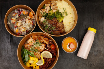 A vibrant spread of healthy gourmet meals, featuring a black sesame-crusted salmon bowl with couscous and asparagus, a grilled chicken bowl with roasted potatoes and Brussels sprouts, a matcha waffle 