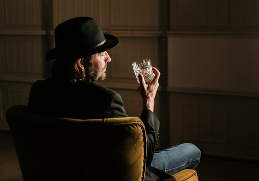 profile of man drinking whiskey