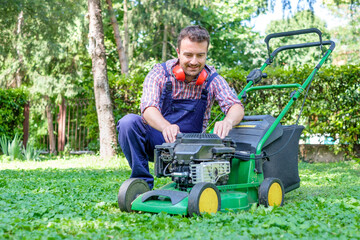 Man portrait mowing the lawn with lawnmower