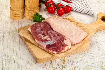 Raw duck breast over board