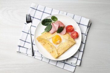 Delicious crepe with egg, ham and parmesan cheese served on white wooden table, flat lay