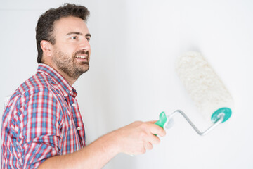 One guy whitewashing the wall for room renovation