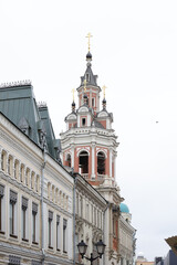 pink bell tower church on the city street
