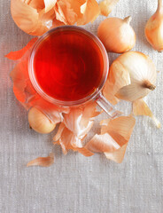 Onion peel tea or natural color for easter on textile background, from above top view, copy space