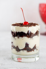 Brownie cake trifle, Black forest, Schwarzwald dessert with chocolate biscuit , whipped cream and cherries. Vegan dessert. Vertical orientation.
