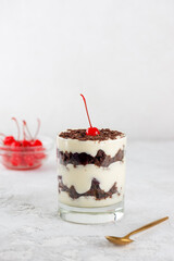 Brownie cake trifle, Black forest, Schwarzwald dessert with chocolate biscuit , whipped cream with shea butter and cherries in a glass. Vegan dessert. Vertical orientation.