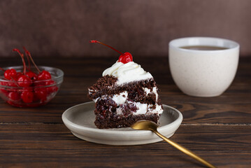 Piece of brownie cake, Black forest or Schwarzwald dessert with chocolate biscuit , whipped cream and cherries. Vegan dessert.