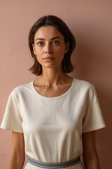 Fototapeta premium arafed woman in a white dress standing against a pink wall