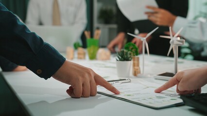 A dynamic business meeting in a modern office setting where team members collaborate on project...
