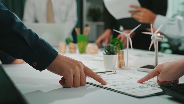 A dynamic business meeting in a modern office setting where team members collaborate on project plans, focusing on innovative and sustainable solutions for future growth. SACTR - Powered by Adobe