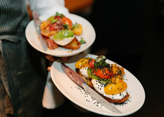 Deliciously crafted dishes with fresh vegetables served at a trendy urban restaurant during evening hours