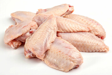 Fototapeta premium Close-up image of several fresh, raw chicken wings arranged on a white surface.