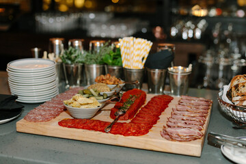 Delicious charcuterie board featuring cured meats and accompaniments in a stylish setting