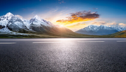Open Road to the Mountains: A vast expanse of asphalt road stretches towards a majestic mountain range. The sky is painted with the warm hues of sunrise and sunset.