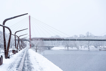 Bridge over the river in a snowfall