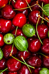 Freshly gathered juicy colorful berries gooseberries, blueberries,cherry.Vegan and vegetarian concept.Top view