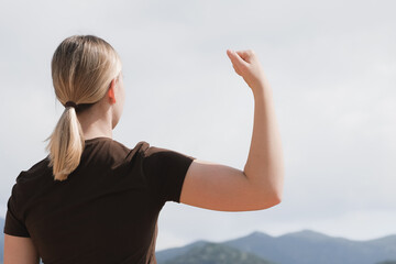woman raises her fist in solidarity, symbolizing empowerment and action for gender equality. A powerful  International Women?s Day, activism, global movement  AccelerateAction for women?s rights