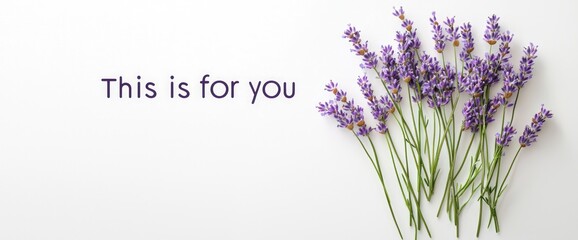 "This is for you" with soft lavender flowers placed beside on white